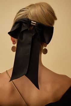 Indulge in a touch of luxury with our Glossy Satin Bow Barrette. Featuring an ultra elevated bow with a metal center, this barrette offers a sophisticated and exclusive touch to any hairstyle. Available in two sleek color options, add a soft satin fabric to your look. Black Tie Optional, Glam Boho, Bows Christmas, Big Hair Bows, Bow Barrette, Halo Headband, Headband Jewelry, Cocktail Jewelry, Elevated Basics