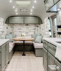 the inside of a camper with lots of counter space and seating area in it