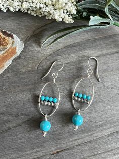 These are artisan made earrings. I hand crafted the hoops and added turquoise wired in and a pretty turquoise drop below. Finished with silver plated earrings wires.  #beadedartbyv #beadedearrings #beadedjewelry #HandCraftedJewelry #artisanjewelry #artisanmade #turquoiseearrings Turquoise Dangle Hoop Earrings Wire Wrapped, Turquoise Wire Wrapped Dangle Hoop Earrings, Artisan Turquoise Beaded Earrings With Ear Wire, Handmade Turquoise Sterling Silver Hoop Earrings, Artisan Nickel-free Turquoise Hoop Earrings, Turquoise Round Beaded Earrings With Ear Wire, Turquoise Wire Wrapped Beaded Earrings As Gift, Handmade Turquoise Silver Plated Wire Jewelry, Handmade Turquoise Silver-plated Wire Jewelry