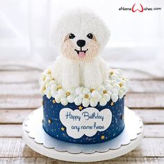 a white dog is sitting on top of a blue birthday cake with stars and flowers