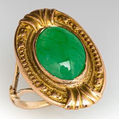 This awesome vintage ring features engraved floral details and contains one (1) oval cabochon cut natural jadeite jade set into a bezel. The ring measures 19.8mm at the top, rises 3.5mm above the finger, tapering to 1.2mm wide and 1.1mm thick at the base of the shank. This ring is currently a size 2.5 and can be sized up. Formal Oval Jade Emerald Ring, Antique Emerald Ring Oval Cabochon, Antique Emerald Ring With Oval Cabochon, Antique Oval Emerald Ring, Antique Green Emerald Ring With Polished Finish, Antique Oval Engraved Emerald Ring, Antique Engraved Oval Emerald Ring, Vintage Oval Carved Engraved Ring, Classic Oval Carved Ring