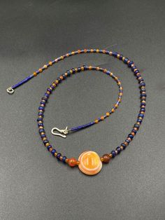 The beautiful ancient old Luk Mik or magic eye bead from Himalaya Tibet along with some blue ancient glass beads along with some orange color carnelian and lapis beads as spacers in the mala necklace Lukmik means goat's eye These ancient stones can be in Carnelian and Agate forms and are natural good condition we provide fast and free shipping service world wide Czech Glass Spiritual Beads, Spiritual Czech Glass Round Beads, Spiritual Orange Gemstone Beads And Cabochons, Spiritual Orange Gemstone Beads, Magic Eyes, Carnelian Beads, Mala Necklace, Tibet, Gold Beads