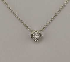 "18 kt white gold pendant. Set with 0.15 carat F-VS2 diamond. The Diamond can be upgraded in size or quality or lesser size and quality. The pendant comes with an 18 kt 1.1 mm 16\" cable chain.                The Diamond is certified. Als available in yellow gold or Platinum." Formal Diamond White Square Pendant Necklace, Formal Solitaire Necklace With Brilliant Cut Square Pendant, Formal Square Pendant Solitaire Necklace With Brilliant Cut, Formal Brilliant Cut Solitaire Necklace With Square Pendant, Formal White Gold Diamond Necklace With Square Pendant, Formal Sterling Silver Solitaire Necklace With Square Pendant, Formal Solitaire Necklace With Square Sterling Silver Pendant, White Diamond Necklace With Square Pendant For Formal Occasions, Formal White Gold Diamond Necklace With Rectangular Pendant