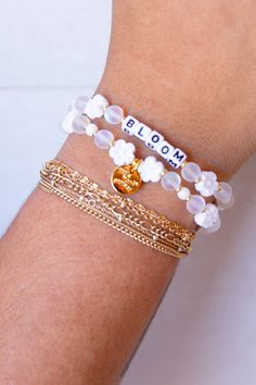 Embrace your personal growth and flourish with our "Bloom" bracelet from Little Words Project. This delicately crafted piece symbolizes new beginnings and the beauty of blooming where you are planted. Perfect for inspiring daily positivity and strength, it features elegant flower beads and a reminder to thrive in all aspects of life. Whether you're treating yourself or gifting a loved one, the "Bloom" bracelet is a chic reminder to keep growing and shining. Celebrate your journey with this beaut Dainty White Hypoallergenic Bracelets, Dainty Hypoallergenic White Bracelets, Dainty White Hypoallergenic Bracelet, Dainty White Charm Bracelet For Everyday, Delicate White Adjustable Jewelry, White Dainty Flower Shaped Beaded Bracelets, Delicate White Flower Beaded Bracelets, Delicate White Flower Shaped Beaded Bracelets, Delicate White Hypoallergenic Jewelry