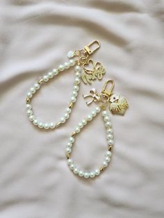 Pearl keychains to accessorize your wristlets, airpods or use as a cute keychains. Also makes perfect gifts for loved ones. Circumference is 9 inches. Comes with an optional white letter charm Trendy Key Clip Keychain As Gift, Trendy Keychain With Key Clip For Gift, White Bag Charm Keychain For Everyday Use, White Keychain With Key Clip For Gift, White Keychain With Key Clip Gift, Cute White Keychains For Everyday Use, Trendy White Keychain With Key Leash, White Bag Charm Keychain As A Gift, White Bag Charm Keychain Gift