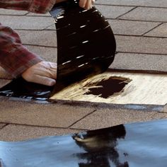 a person with their foot on a piece of wood that is laying on the ground