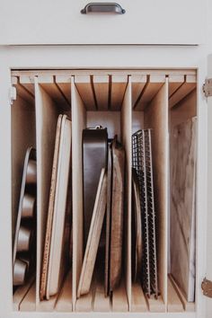 the kitchen organization drawer is filled with wooden utensils