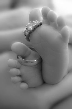 a baby's foot with a ring on it