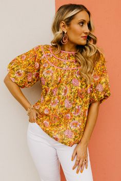 The Kira Floral Woven Top | MOD Boutique Feminine Floral Print Smocked Top For Summer, Summer Feminine Floral Print Smocked Top, Feminine Floral Smocked Top For Summer, Feminine Summer Smocked Top With Floral Print, Cotton Smocked Top For Spring Daywear, Spring Pink Blouse With Smocked Bodice, Pink Smocked Bodice Blouse For Spring, Cotton Blouse With Smocked Bodice, Relaxed Fit, Feminine Cotton Peasant Top For Spring