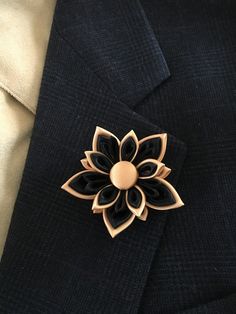 "Men's lapel pin. The pin is made out of satin and organza ribbons in the Japanese kanzashi technic. The flower measures approx. 2.5\" across. The center of the flower is adorned with a ribbon covered button. This listing is for one lapel pin in BLACK/GOLD color combination. This beautiful lapel pin can be made in almost any color or color combination. If you want to request a color please contact me before ordering for availability. The lapel pin is handmade with top quality materials and made Luxury Wedding Lapel Pin For Men, Formal Rose Gold Flower Brooches, Formal Rose Gold Flower Brooch, Formal Rose Gold Flower Shaped Brooch, Elegant Rose Gold Lapel Pin Brooch, Elegant Handmade Flower Pins As Gift, Elegant Handmade Flower Pins For Gifts, Elegant Formal Brooches With Handmade Flowers, Formal Handmade Flower Brooches