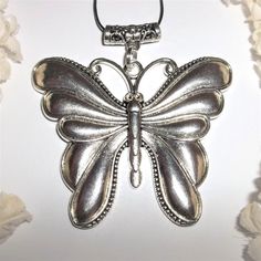 Silver Butterfly Necklace, Statement Necklace, Pendant, Butterfly, Necklace A143 This Extra Large Butterfly Necklace Is Sure To Get You Lots Of Compliments. Brand New Nwt And Handmade By Me - Wvluckygirl. Hand Crafted With An Antiqued Silver Toned Costume Jewelry Butterfly Charm. If You Look At The Bail On Top There Is A Lovely Floral Design. The Pendant And Bail Measure 2 3/4 Inches Tall And 2 3/4 Inch Wide. Very Big And Heavy. A Great Statement Piece. Comes With A 36 Inch Black Nylon Rope Cord Elegant Silver Metal Butterfly Necklace, Adjustable Silver Pendant Charm Necklaces, Adjustable Silver Pendant Charm Necklace, Silver Metal Necklace With Butterfly Charm, Handmade Silver Charm Necklaces For Party, Silver Necklace With Butterfly Charm, Silver Butterfly Charm Jewelry, Silver Butterfly Charm Necklace As Gift, Silver Butterfly Charm Necklace Gift