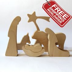 a wooden nativity scene with an ornament hanging from it's side