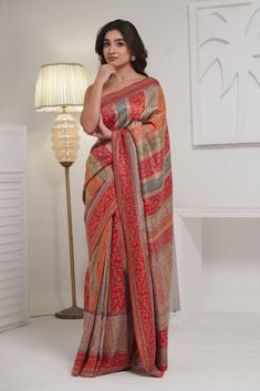 Beige Kani Saree in silk fabric is accentuated with Kani Jamawar weaving  in beautiful colours and stripes patterns exhibiting floral designs. Paisleys and bootis along its skirt and pallu make it stand out. This saree is accompanied with a blouse piece in contrasting color with Kani weaving in booti pattern. The design inspiration for this Pashmina Silk saree is drawn from the heritage weaves of ancient Pashmina shawls from our history that dates back to the Mughal era.  Kani is an ancient and Luxury Bohemian Pashmina Saree, Luxury Jamawar Saree With Pallu Detail, Luxury Jamawar Fabric With Zari Weaving, Luxury Handloom Tussar Silk Pashmina Shawl, Multicolor Pre-draped Saree For Eid, Designer Tussar Silk Pre-draped Saree With Printed Border, Festive Tussar Silk Pre-draped Saree With Printed Border, Festive Multicolor Chanderi Pre-draped Saree, Multicolor Pre-draped Saree With Zari Weaving