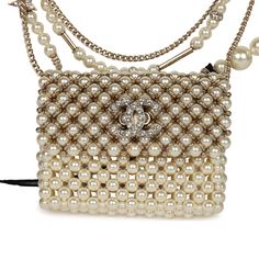 This Chanel flap bag pendant necklace is made of pearls with light gold tone hardware and features a front flap with signature CC magnetic closure, and a light gold tone chain link with pearl, CC pendants, and star pendants.Collection: 23AOrigin: FranceCondition: New and never wornAccompanied by: Chanel pouch, retail UPC and carebookMeasurements: 2" x 1.75" pendant; 23.5" chain length Chanel Pouch, Lv Neverfull Mm, Chanel Pearl, Neverfull Mm Monogram, Chanel Pearls, Chanel Flap Bag, Chain Shoulder Bag, Fendi Bags, Flap Bag