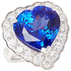 This ring designed by David Jerome is from his private collection and features one heart cut Tanzanite totalling 15.44cts sourced in the D block mine Tanzania. Set with round brilliant cut Diamonds totalling 1.74cts mounted in an 18k white gold setting. Finger size UK M, EU size 52, USA size 6 1/4. David prides himself in only sourcing the finest and most exclusive gemstones whose natural beauty and colour enhance the settings he creates for each piece. These exclusive designs offer buyers a uni Heart Cut Ring, Tanzanite Diamond Ring, Tanzanite Diamond, Contemporary Ring, Gold Diamond Rings, Round Brilliant Cut Diamond, Cluster Ring, Tanzania, Ring Designs