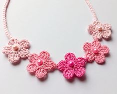 "This minimalistic crochet necklace is made of 100% cotton.  Color: gradient pink (flowers). Five flowers are decorated with matching beads.  Closure - ties (14\" on each side).  Suitable for all seasons, different styles of clothing.  If you have any questions about this item, please feel free to contact me.  Thank you for visiting !" Cute Pink Necklace For Spring, Cute Pink Necklaces For Spring, Cute Pink Flower-shaped Necklace, Cute Pink Flower Shaped Necklace, Handmade Pink Necklaces For Spring, Handmade Pink Flower Necklace, Cute Pink Flower Necklace, Pink Crochet Bohemian Necklace, Pink Crochet Necklace