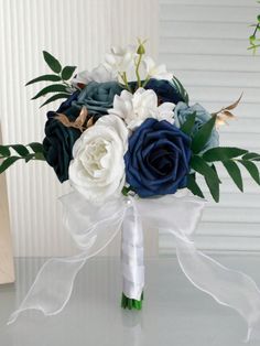 a bridal bouquet with blue and white flowers