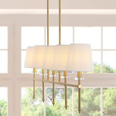 At just over three-feet long, this linear pendant is perfectly sized to hang over a kitchen island or dining room table. The simple, elegant frame features lucite accents; the five warm LED bulbs are softened by ivory linen shades. This versatile linear pendant is ideal for modern, minimalist dining rooms as well as traditional spaces. JONATHAN Y Sophie 38.5" Iron Mid-Century 5-Light Brass Gold Modern/Contemporary Linear LED Large Hanging Kitchen Island Light | JYL9919A Dining Room Round Lighting Over Table, Rectangle Chandelier Over Kitchen Island, Island Linear Lighting, Dining Room Light Fixtures Over Table, Hallway Paneling, Linear Chandelier Dining Room, Dining Room Lighting Over Table, Dining Lights, Floor Office