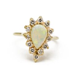 an opalite and diamond ring, with the center stone set in yellow gold