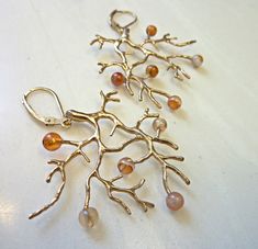 Carnelian Wild Branch Earrings, Bronze or Sterling Silver Organic branch earrings are hand-cast in golden bronze with secure 14k gold-filled lever-back ear wires. They are highlighted with 4mm Carnelian gemstone beads, like tiny berries. Wild and strong, yet delicate, and a bit of nature for your ears. They can also be cast in all sterling silver with sterling lever-back ear wires. The branch was cast in solid eco-friendly bronze using lost-wax casting. I start with a wax model, and then a plast Gold Natural Stones Earrings Nature-inspired, Gold Nature-inspired Earrings With Natural Stones, Nature-inspired Gold Earrings With Natural Stones, Elegant Gold Carnelian Earrings, Gold Carnelian Dangle Earrings, Nature-inspired Gold Wire Wrapped Earrings, Gold Carnelian Jewelry With Matching Earrings, Gold Carnelian Earrings With Ear Wire, Carnelian Gold Earrings With Ear Wire