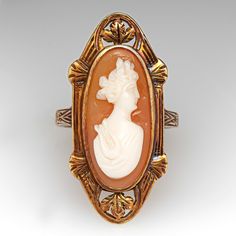 This lovely antique shell cameo cocktail ring has a nice low profile design and is crafted of 14k yellow gold. There are well preserved intricate details on the ring face and band and it has a gentle worn patina that further accentuates the designs. The ring is currently size 4.75 and polishing is not recommended, it is great as is. Antique Cameo Ring Collectible, Art Deco Cameo Ring For Collectors, Vintage Carved Yellow Gold Rings, Vintage 14k Gold Cameo Rings, Art Deco Cameo Ring Collectible, Art Deco Cameo Collectible Rings, Antique Carved Collectible Ring, Vintage Oval Cameo Ring, Victorian Gold Cameo Rings