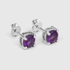 Amethyst Stud Earrings / Natural Amethyst Round Stud Earrings / February Birthstone EarringsFlaunt yourself with these amethyst stud earrings. The natural gemstones have a combined weight of 1.53  carats and are set in .925 sterling silver with rhodium plating. The purple hue of these earrings adds a pop of color to any look!  The understated design and vibrant stones make these perfect for every occasion.amethyst earrings, amethyst silver earrings, amethyst stud earrings, natural amethyst silve Formal Purple Round Earrings, Purple Amethyst Earrings For Pierced Ears, Purple Amethyst Jewelry For Pierced Ears, Purple Sterling Silver Earrings With Prong Setting, Round Amethyst Gemstone Earrings, Purple Amethyst Earrings With Prong Setting, Nickel-free Round Purple Earrings, Purple Birthstone Earrings For Formal Occasions, Formal Purple Birthstone Earrings