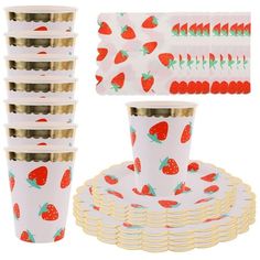 a stack of plates and cups with strawberries printed on the front, gold rimmed lids