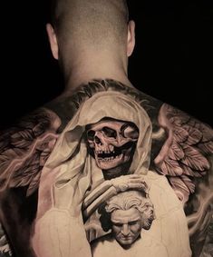 the back of a man's neck with an angel and skull tattoo on it