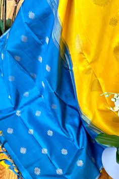 This stunning borderless kanjivaram silk saree in turmeric yellow is handwoven. The simple pallu is in teal blue color. The body is adorned with rangoli/kolam motifs in different sizes in gold zari. The blouse piece is in the same color as the pallu. Approximate Length 6.5 mtrs (inclusive of blouse length)Approximate height - 44 - 50” Approximate weight - 1.3 lbs Kindly Note : The colors you see on your device may vary due to the color reproduction, brightness and resolution of individual device Blue Paithani Silk Saree With Self Design, Blue Paithani Silk Saree For Festivals, Blue Katan Silk Saree For Puja, Blue Tussar Silk Saree With Zari Weaving, Blue Tussar Silk Saree For Diwali, Blue Katan Silk Saree With Traditional Patterns, Blue Paithani Silk Saree With Traditional Patterns, Blue Paithani Silk Dupatta With Traditional Patterns, Blue Paithani Silk Dupatta For Festivals