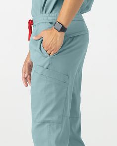 Comfort meets practicality. With 10 functional pockets and an adjustable waistband, these pants were made for you to move. These are the ultimate everyday go-to pants. Constructed with TENCEL™ Lyocell fibers to inhibit bacterial growth, provide breathability, and enhance comfort. - Classic Fit - Inseam 29" - Total of ten pockets ✓ Two deep pants pockets ✓ Two back zipper pockets ✓ Six side pockets - Faux fly - Waistband with adjustable drawstring - Ribbed ankle cuffs with signature stripes Spring Is Coming, Adjustable Waistband, Ankle Cuffs, Scrub Pants, Scrub Tops, Blue Stone, Scrubs, Stripes, Zipper