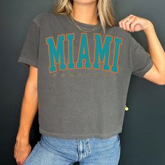 Vintage Miami Football cropped Tshirt Miami Shirt Football T-shirt retro Miami Tee Football Gift Comfort Color Crop Top -Please check Color and Size Charts before placing the order. You can find them in the listing's photos (Depending on what device you are viewing this listing colors may vary slightly). -Returns and exchanges are accepted only if there are defects "No Extra Costs" We create custom t-shirts with great designs for everyone's liking. If you don't find the size or color you would l Short Sleeve Cropped T-shirt With Letter Print For College, Cropped Short Sleeve T-shirt With Letter Print For College, Cropped Short Sleeve Letter Print T-shirt For College, Cropped Letter Print T-shirt For College, Retro Crew Neck Cropped T-shirt With Screen Print, Retro Crew Neck Crop Top With Screen Print, Vintage Cropped T-shirt With Letter Print For Streetwear, Miami College, Retro Miami