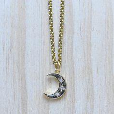 This necklace is made from a gold plated pendant. The charm is in the shape of a crescent moon. The front of the crescent moon has three stars with clear cz crystals. The necklace is finished off with a gold plated stainless steel chain. You can choose the style and length of the chain. Please choose the length you would like the necklace in. Please choose the chain style you would like your pendant on. Please note that all necklaces are handmade and may differ from the pictured. The picture sho Celestial Crescent Charm Necklaces With Adjustable Chain, Celestial Crescent Necklace With Adjustable Chain, Crescent Moon Charm Necklace, Celestial Crescent Brass Necklace, Gold Crescent Celestial Necklace, Crescent Moon Phase Brass Necklace, Brass Crescent Moon Phase Necklace, Celestial Crescent Gold Necklace, Crescent Moon Phase Metal Necklace