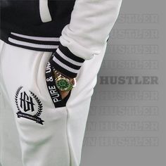 Stay comfortable and stylish with the Home Grown Hustler varsity set. This set includes a varsity jacket and matching jogger pants, both made from a soft and stretchy fabric. The relaxed fit allows for maximum mobility, while the bold logo adds a touch of flair. Whether you're running errands, meeting up with friends, or just lounging at home, this varsity set is a perfect choice. Plus, it's easy to care for – just toss it in the wash and it's good as new. Available in sizes S-XXXL, this varsity White Cotton Varsity Jacket With Baseball Collar, White Collegiate Cotton Varsity Jacket, White Cotton Varsity Jacket In College Style, White Cotton Varsity Jacket, White Cotton College Style Varsity Jacket, White Sweatpants With Ribbed Waistband For Sports, Leisure Sportswear Joggers For Sports Season, White Casual Varsity Jacket With Baseball Collar, Casual White Varsity Jacket With Baseball Collar