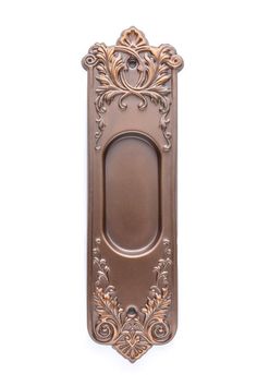 an ornate door handle on a white wall