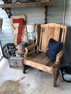 a wooden chair sitting on top of a cement floor next to a shelf filled with items