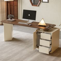 an office desk with a computer on it in a living room next to a window