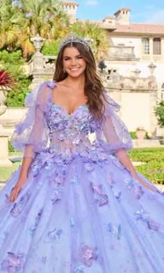 Puff sleeve glitter tulle a-line quinceanera ball gown with sweetheart neckline and floral embellishment. Purple And Blue Quinceanera Dresses, Light Purple Quince Dresses, Light Purple Quinceanera Dresses, Purple Quince Dress, Purple Quinceanera Dresses, Purple Quince, Quinceanera Dresses Blue, Floral Embellishment, Lace Gown Styles