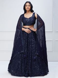 Introducing our amazing navy blue sequins georgette reception wear lehenga choli, the perfect ensemble for engagements, receptions, and parties. This stunning navy blue lehenga is crafted with georgette material and adorned with exquisite sequin and thread embroidery work, making it a truly eye-catching piece.
The lehenga comes in a rich navy blue color, which adds a touch of elegance and sophistication to your look. It is semi-stitched up to 42 inches, ensuring a comfortable and flattering fit Ethnic Outfits Indian, Dark Blue Lehenga, Navy Blue Lehenga, Dark Midnight Blue, Navy Blue Gown, Blue Colour Dress, Georgette Lehenga, Blue Lehenga, Global Dress