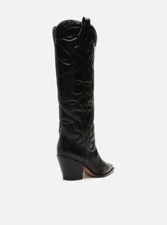 Black leather boot. The style features a mid-shaft, a low stacked block heel, and a pointed toe. It has a western embroidery on the sides of the vamp. There’s no closure and includes a pull-tab on the side of the shaft, making it easy to put on. Why follow this trend? The western boot, also known as cowboy boot, is one of the major trends of the season. Edgy and impressive, it guarantees comfortable and stylish looks. A must-have item of the season, so go for it! Heel Height: 2.8' Outsole Materi Western Boots With Stacked Low Heel, Western Boots With Sculpted Heel For Fall, Pointed Toe Heeled Boots With Stacked Heel For Rodeo, Western Heeled Boots With Stacked Low Heel, Western Low Heel Boots For Fall, Western Low Heeled Boots For Fall, Western Style Low Heeled Boots For Fall, Western Black Boots With Block Heel, Black Western Boots With Block Heel