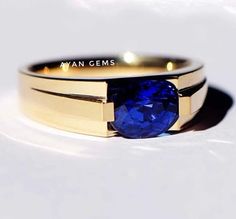 a close up of a ring with a blue stone on the front and back of it