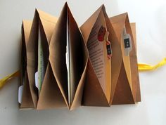 an origami book opened to show the inside pages and attached with yellow string