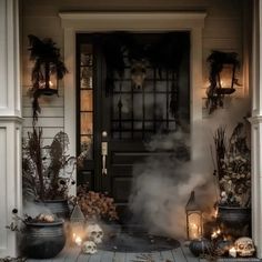 a front porch decorated for halloween with candles and skulls