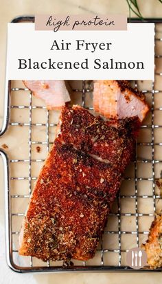 an air fryer rack with salmon on it and text overlay that reads, high protein air fryer blackened salmon