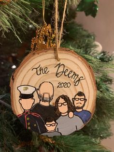 a wooden ornament hanging from a christmas tree with the words the deans on it