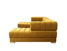 a yellow couch sitting on top of a white floor