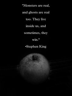 an apple sitting on top of a table next to a black background with a quote from stephen king