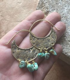 "Swoon! These ooak shield hoops have been hand fabricated using solid brass. These hoops have been heavily textured and stamped with various shapes and tiny stars. Mashan turquoise beads dance along the bottom of these earrings, giving them so much movement! Hammered brass ear wires have been soldered to the tops. Lightweight on the ears. Ready to ship! Xo MATERIALS: Brass, brass wire & Mashan Turquoise beads MEASUREMENTS: Approx 2\" L x 1 1/4\" W These will arrive gift wrapped in an eco friendl Hand Forged Turquoise Brass Jewelry, Bohemian Bronze Nickel-free Hoop Earrings, Artisan Metal Jewelry With Stamped Details, Artisan Stamped Brass Jewelry, Artisan Stamped Metal Jewelry, Rustic Copper Jewelry For Festivals, Bohemian Bronze Earrings With Patina, One Of A Kind Brass Dangle Earrings, Bronze Bohemian Jewelry With Patina