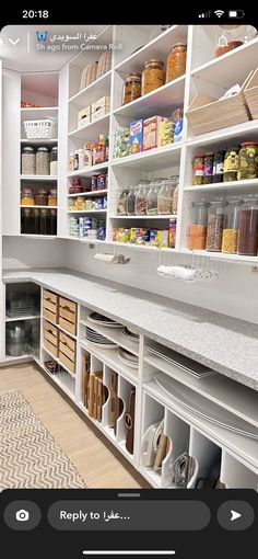 an organized pantry with white cabinets and drawers