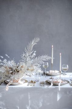 the instagram page shows an image of a table set with white flowers and candles