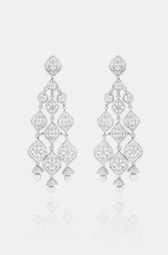 Introducing exquisite long Diamond dangler earrings, adorned with shimmering faux diamonds and graceful pearl drops, set against a pristine white finish. This statement piece exudes elegance and adds a touch of ravishing allure to any ensemble. Finish: Rhodium Material: Brass, Faux Diamonds, Pearls Color: White Size: One Size Closure Type: Push Back Box Contains: 1 Pair of Earrings Long Diamond Earrings, Diamond Danglers, Hand Jewelry Rings, Chain Braid, Artificial Jewelry, Dangler Earrings, Jewelry Indian, Hand Jewelry, Anklet Jewelry